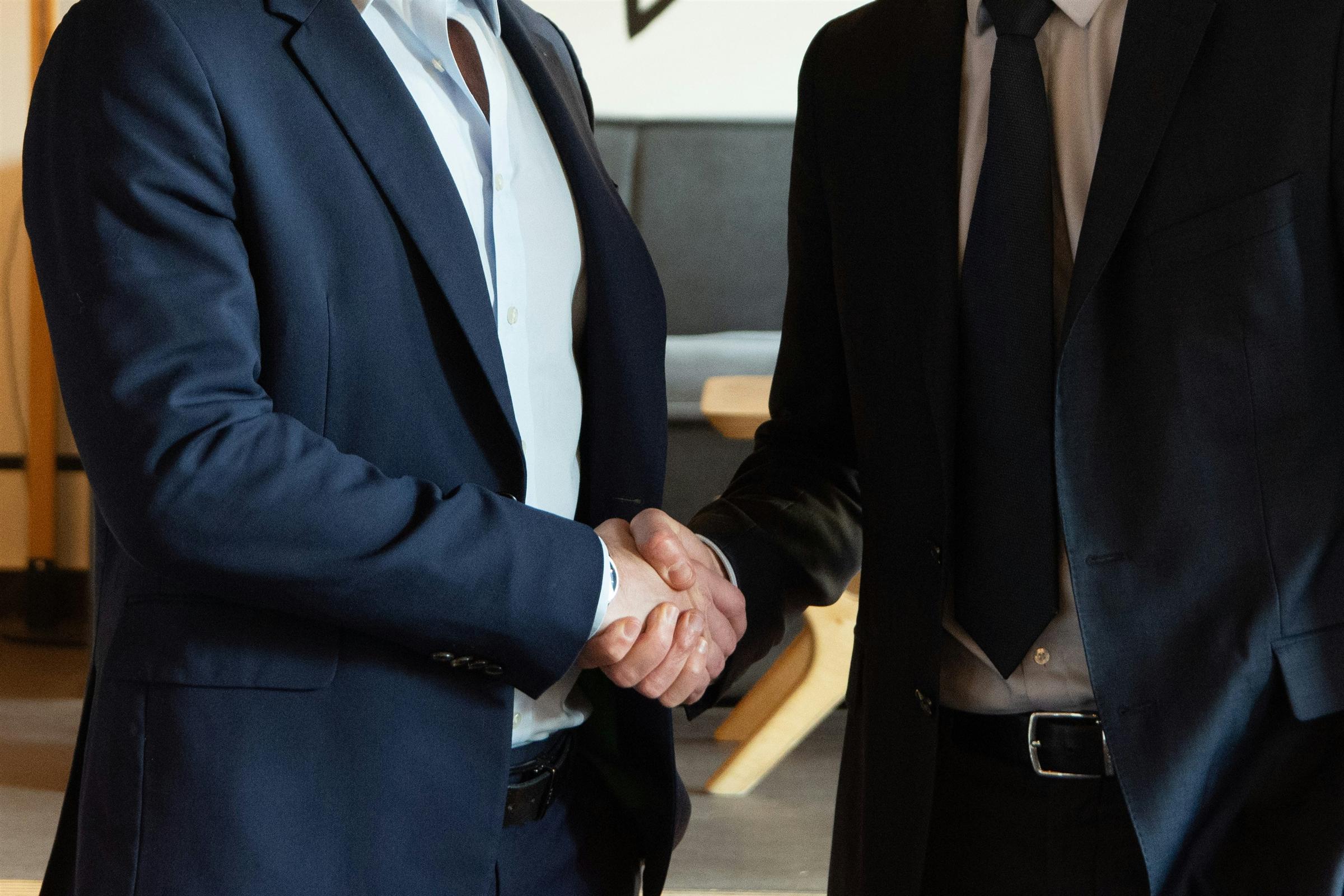 A handshake across a meeting table